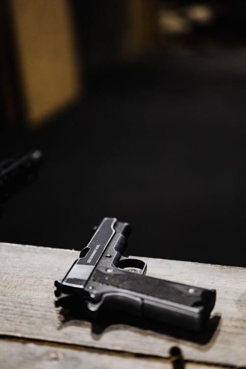 Black pistol on wooden surface - Glock for self-defense