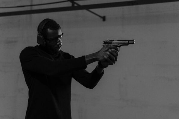 Man with protective gear at indoor shooting range